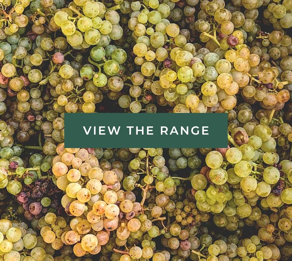 A close-up view of various light green and yellow grapes with a text overlay that says "View the range."