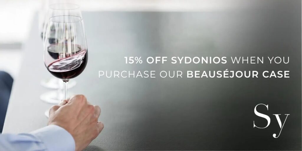 Hand holding a swirling glass of red wine with text offering 15% off Sydonios when purchasing the Beauséjour case.