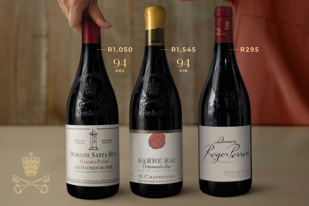Three bottles of red wine labeled Domaine Santa Duc, Barbe Rac, and Domaine Roger Perrin with prices and ratings above them.