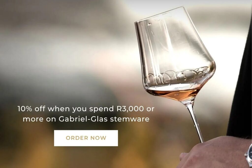 Hand holding a Gabriel-Glas wine glass with rosé, advertising 10% off on purchases over R3,000 with an "Order Now" button.