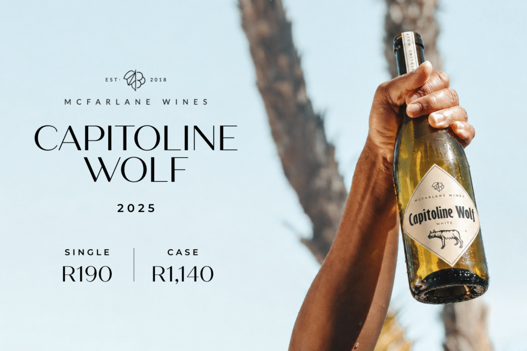 Hand holding a bottle of Capitoline Wolf white wine by McFarlane Wines against a clear sky with pricing details for 2025.